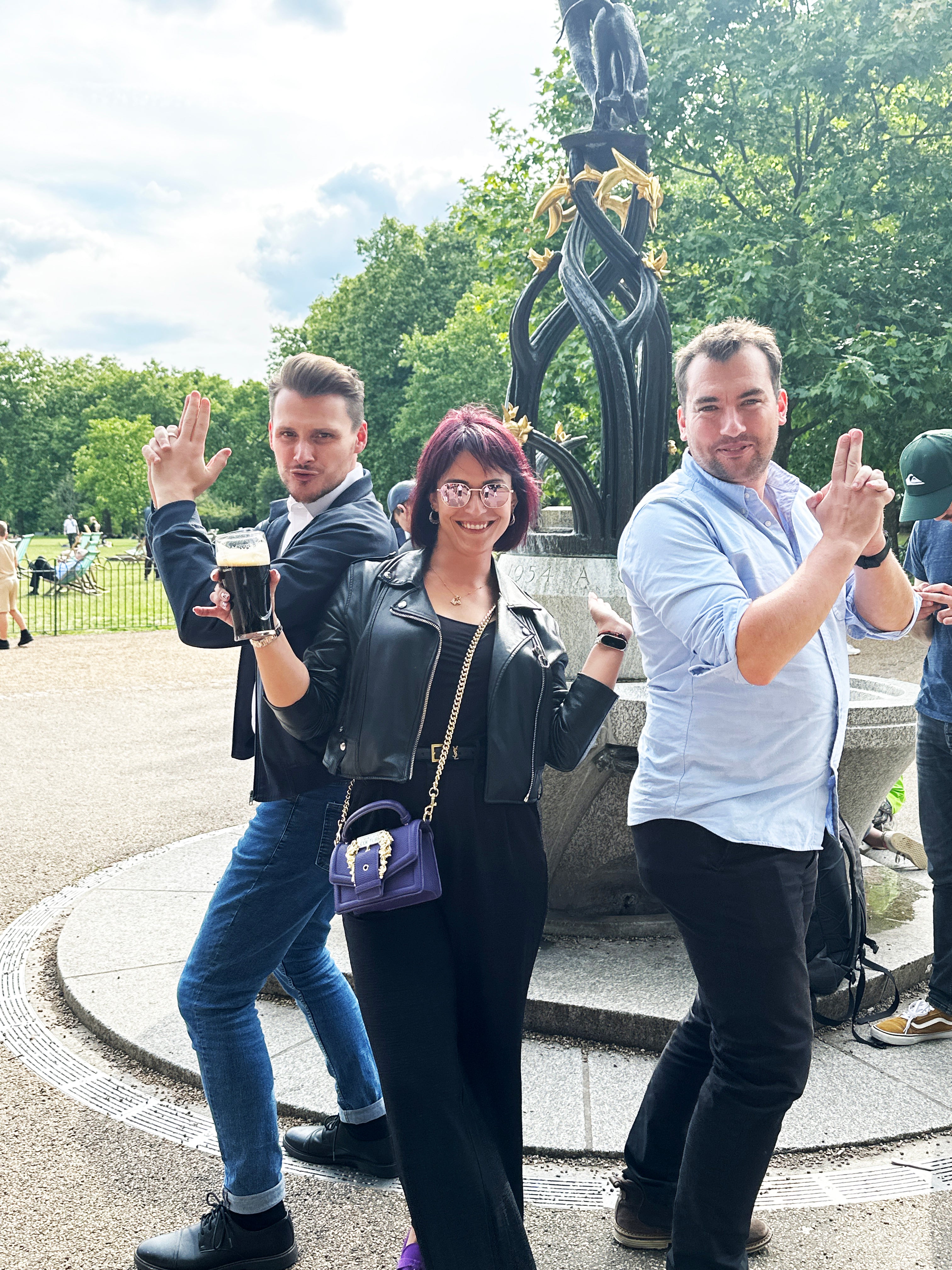 A group of colleagues participating in a photo challenge by acting out a famous movie scene during a team-building event.